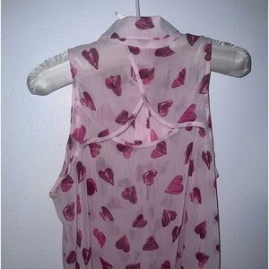 Sheer pink with mauve mixed hearts. Button up w/front pocket. Semi open back.